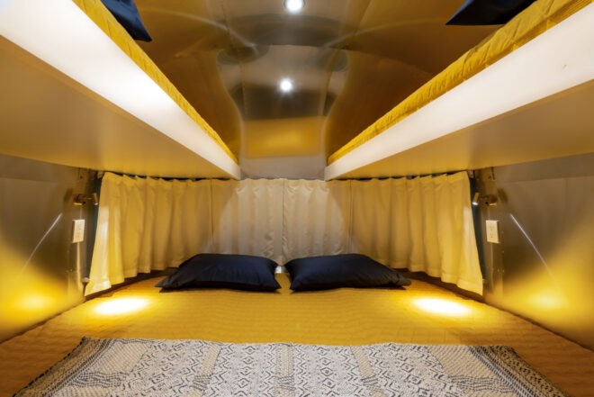 a double bed with mustard-colored decor