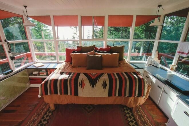 light-filled interior bedroom with brown, red and orange decor
