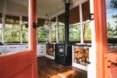 view through open door of living space with wood-burning chimney