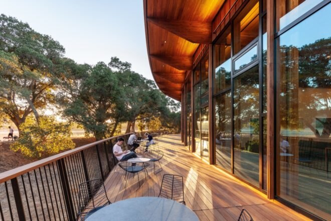 outdoor wooden deck with tables and students