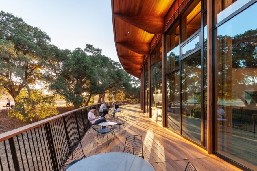 outdoor wooden deck with tables and students