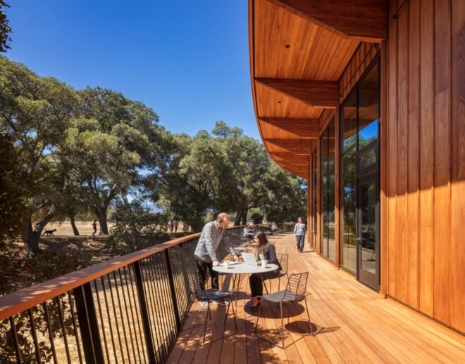 outdoor wooden deck with tables and students