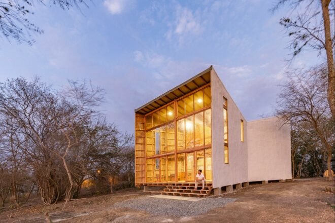 funnel-shaped wooden cabin with all-glass front facade