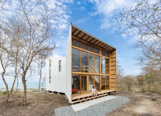 funnel-shaped wooden cabin with glass wall