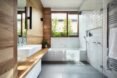 white bathroom with rammed earth walls