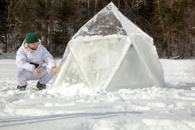 man crafting together a frozen geodesic dome