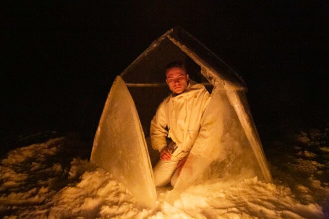 man inside a geodesic ice igloo