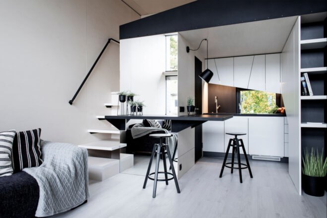 modern living space with white walls and black furnishings