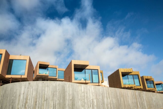series of wooden structures with glass facades