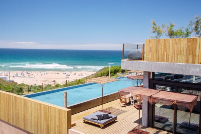 large swimming pool in front of beach