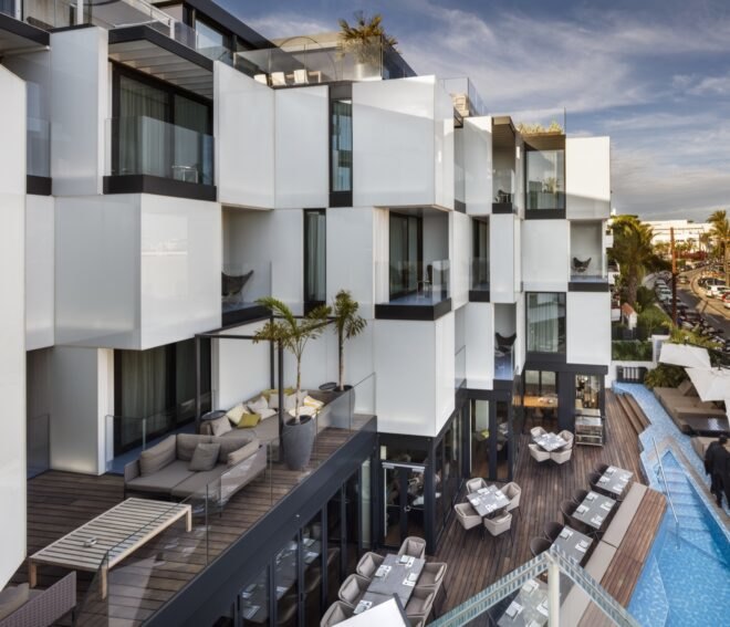 hotel with white and glass blocks on the facade