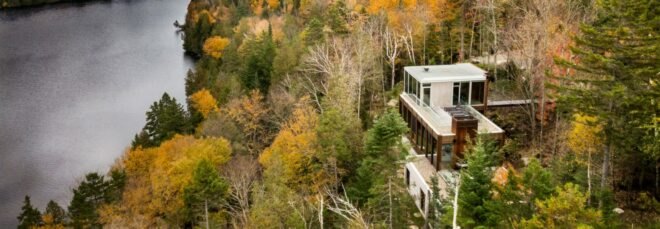 home with various levels surrounded by forest