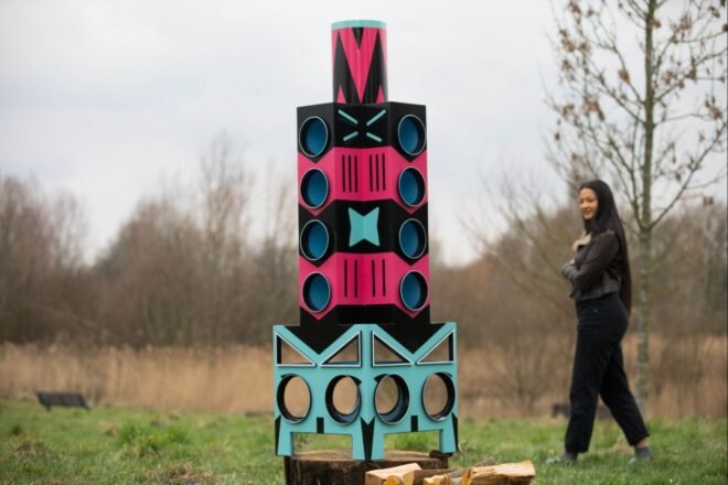 a pink, black and blue tower made for birds