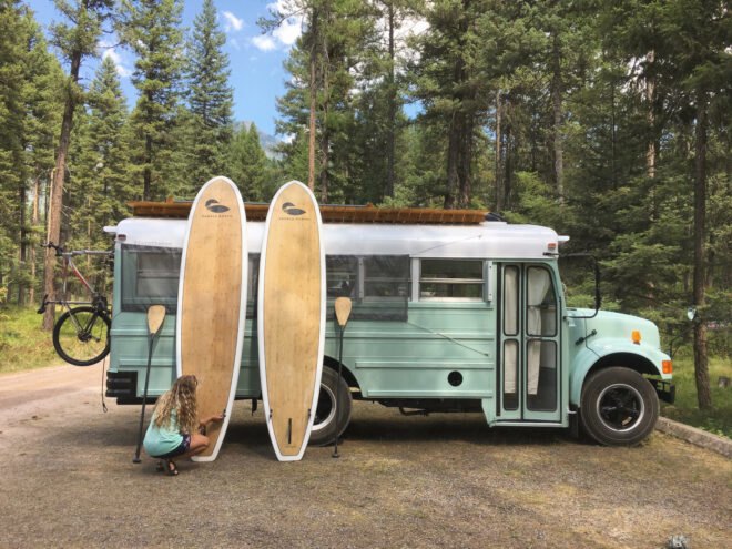 converted school bus with two surf boards