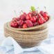 brown biodegradable tableware with bright cherries on plate