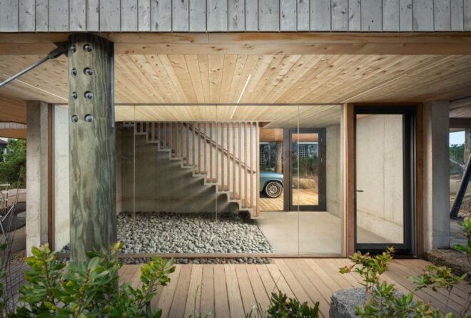 glass-enclosed entryway with wood steps leading to next floor
