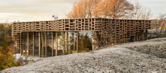 home wrapped in timber slats on rocky landscape