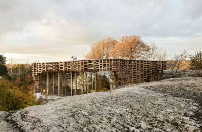 home wrapped in timber slats on rocky landscape