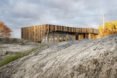 home wrapped in timber slats on rocky landscape