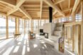 interior living space with wooden beams and concrete flooring