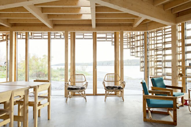 interior living space with wooden beams, concrete flooring and several wood seats