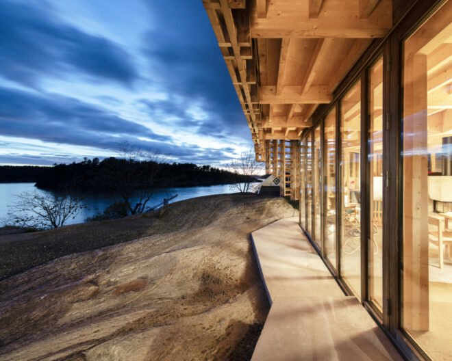 outside of timber home with glass panels