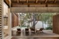 wood chairs on a wood patio by a pool