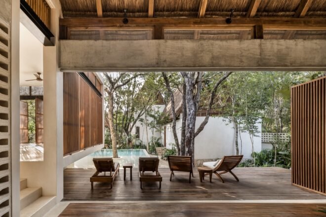 wood chairs on a wood patio by a pool