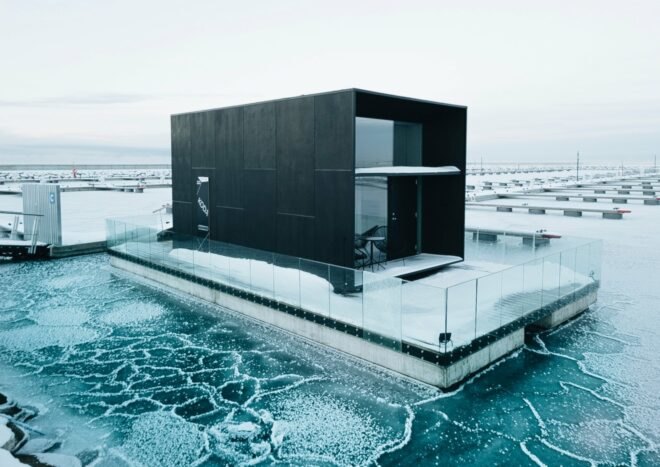 cube-like tiny home set on floating platform on icy waters