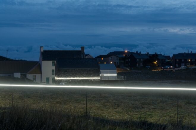 white LED light cutting through middle of homes