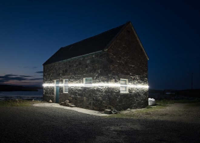 white LED light in middle of stone building