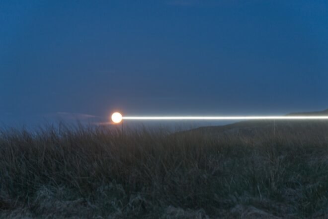 white beam of light on serene landscape