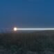 white beam of light on serene landscape