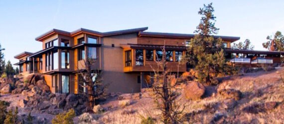 house on hill top over looking scenic landscape