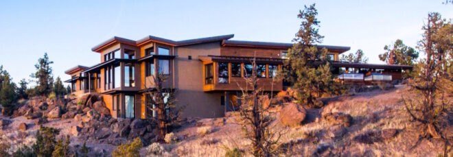 house on hill top over looking scenic landscape