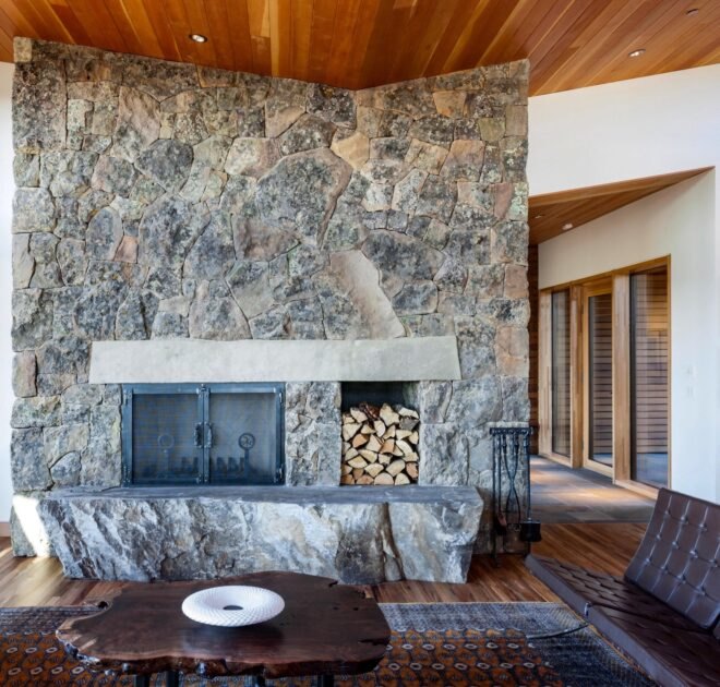 fireplace lined with exposed rock and marble