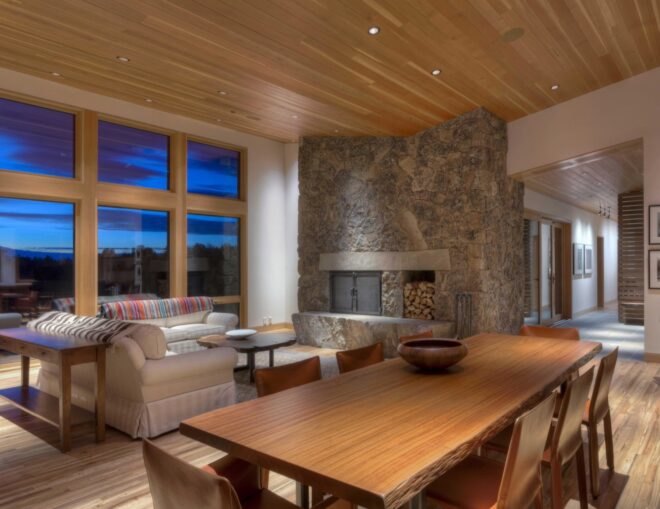 interior living and dining room of the home with wooden table and ceiling