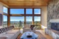 floor to ceiling windows in living room area with tan colored couched