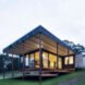 shipping container turned into a home with large windows and a deck