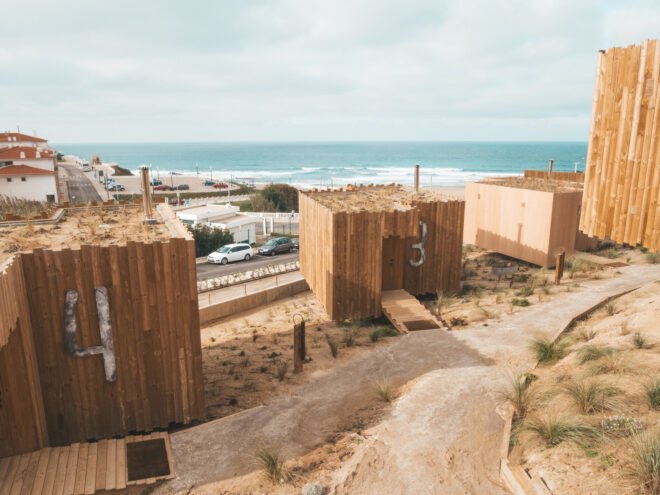 series of wooden structures with green roofs