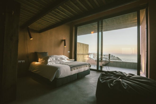 large double bed next to glass doors