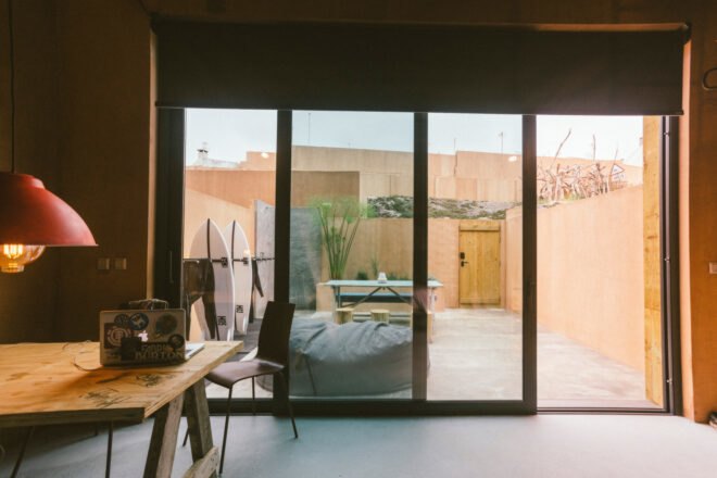 image of living space with sliding glass doors leading out to a patio