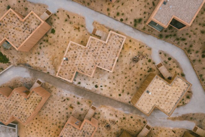 aerial view of wooden structures with green roofs