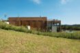 brick home set on grassy landscape