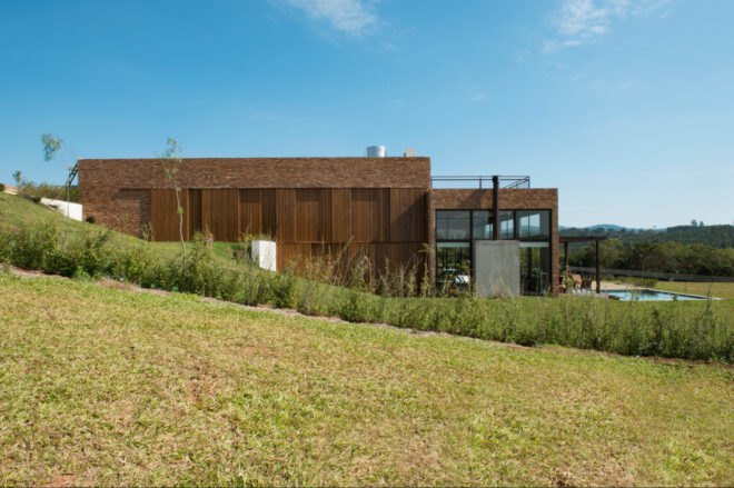 brick home set on grassy landscape