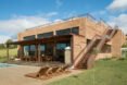 brick home with three large glass facades