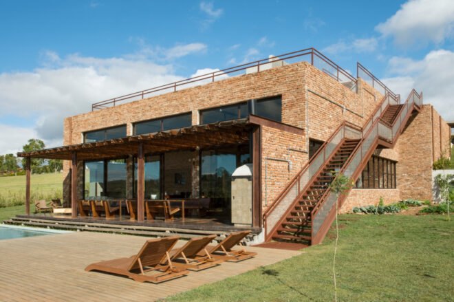 brick home with three large glass facades
