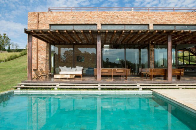 brick home with swimming pool