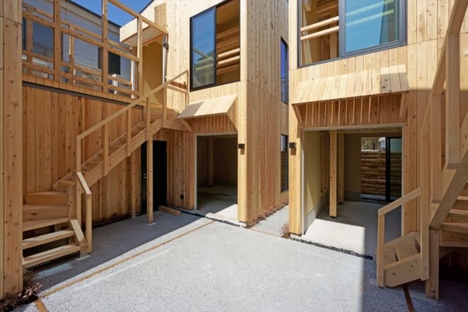 wood buildings with wood stairs leading to open courtyard
