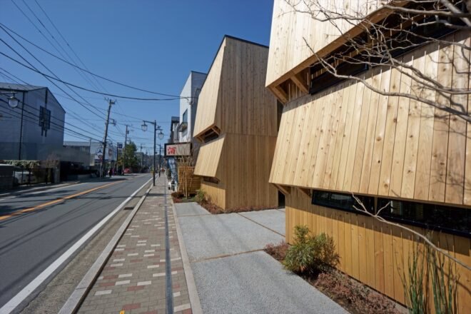 buildings with protruding wood exteriors against a city street